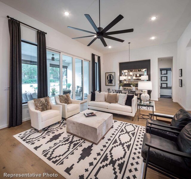 4621 Sandbrock Pkwy, Aubrey, TX 76227 - living room featuring ceiling fan, wood finished floors, recessed lighting, baseboards, and a chandelier