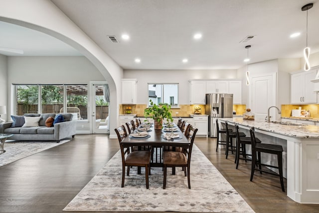 3940 White Clover Ln, Prosper, TX 75078 - dining area featuring recessed lighting, plenty of natural light, dark wood-style floors, and arched walkways