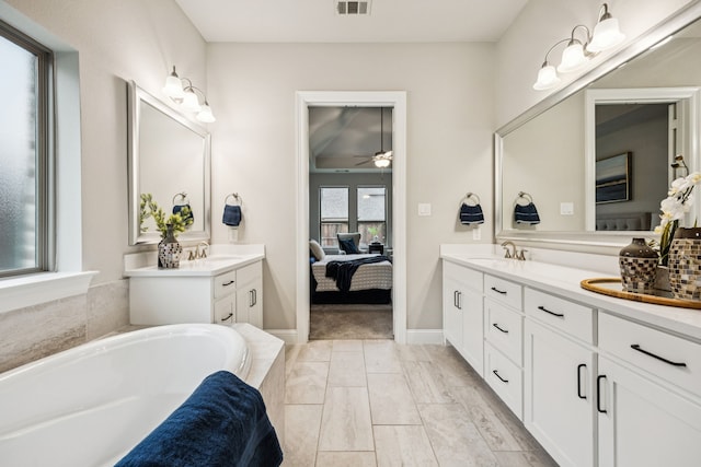 3940 White Clover Ln, Prosper, TX 75078 - bathroom with double vanity, a garden tub, ceiling fan, and ensuite bathroom