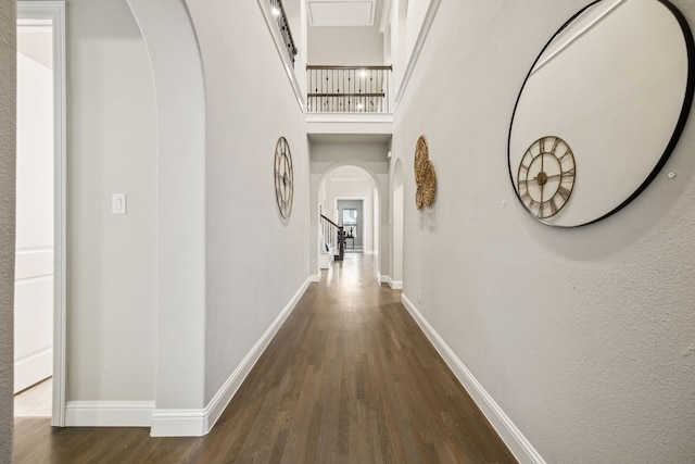 3940 White Clover Ln, Prosper, TX 75078 - hall featuring arched walkways, dark wood finished floors, baseboards, and stairs