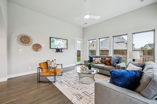 3940 White Clover Ln, Prosper, TX 75078 - living area featuring dark wood-style floors, a ceiling fan, baseboards, and a towering ceiling