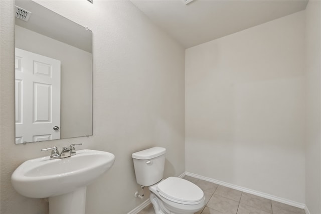 1611 Timpson Dr, Forney, TX 75126 - bathroom featuring a sink, toilet, tile patterned floors, and baseboards