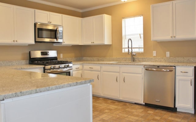 302 N 1st St, Wylie, TX 75098 - kitchen with stainless steel appliances, a sink, ornamental molding, and white cabinetry