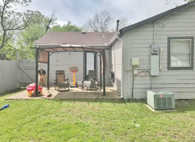 302 N 1st St, Wylie, TX 75098 - rear view of property featuring a patio, central AC, and a shingled roof
