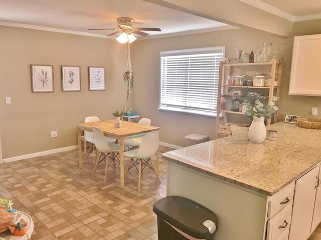 302 N 1st St, Wylie, TX 75098 - kitchen featuring baseboards, ceiling fan, white cabinetry, ornamental molding, and light stone countertops