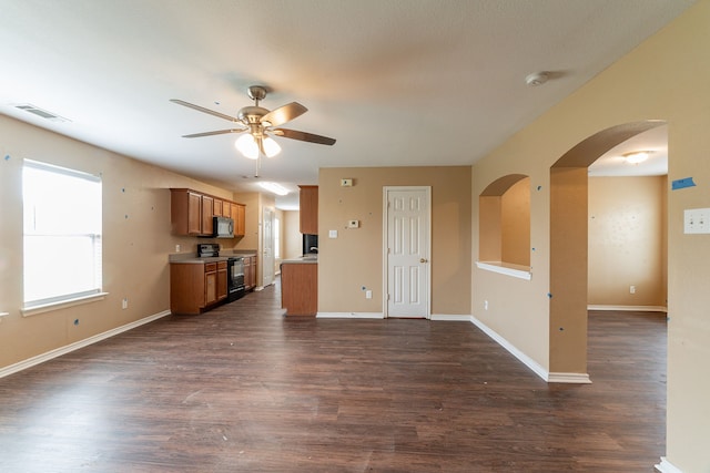 1005 Bainbridge Ln, Forney, TX 75126 - kitchen with black appliances, open floor plan, ceiling fan, brown cabinetry, and dark wood-style flooring