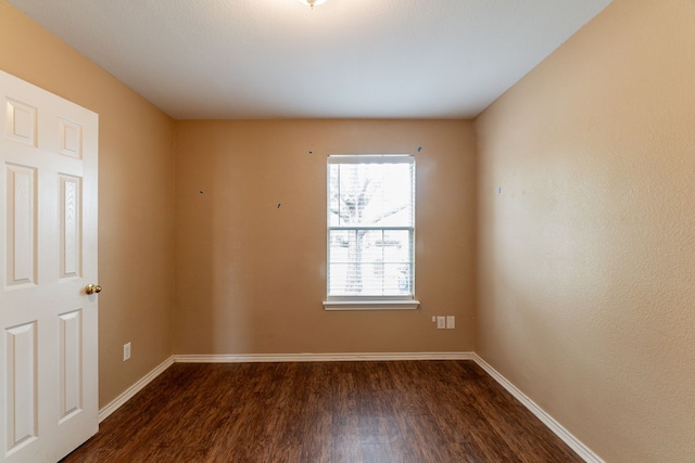 1005 Bainbridge Ln, Forney, TX 75126 - spare room with dark wood-type flooring and baseboards