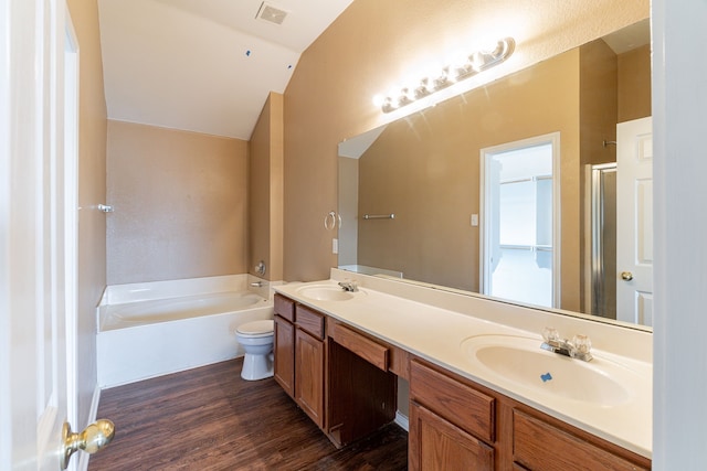 1005 Bainbridge Ln, Forney, TX 75126 - bathroom featuring lofted ceiling, a garden tub, double vanity, wood finished floors, and a shower with shower door