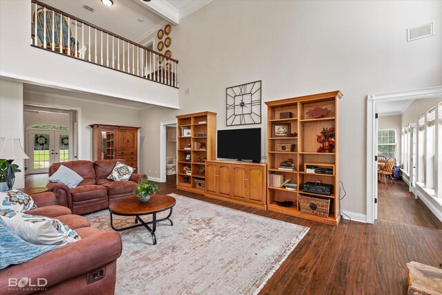 10198 Castanedo Ct, Keithville, LA 71047 - living room featuring a towering ceiling, ornamental molding, dark wood-style flooring, baseboards, and french doors