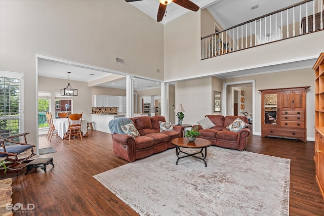 10198 Castanedo Ct, Keithville, LA 71047 - living room with dark wood finished floors, ceiling fan, a towering ceiling, and ornamental molding