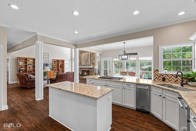 10198 Castanedo Ct, Keithville, LA 71047 - kitchen featuring a sink, crown molding, a stone fireplace, a peninsula, and open floor plan