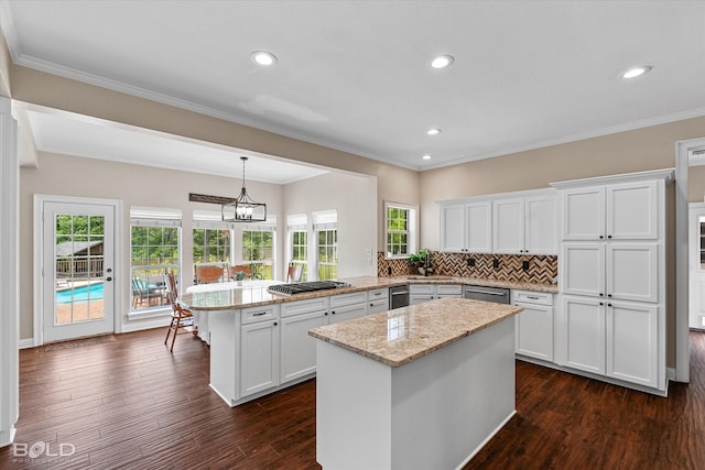 10198 Castanedo Ct, Keithville, LA 71047 - kitchen featuring a peninsula, appliances with stainless steel finishes, dark wood-style floors, a center island, and white cabinets