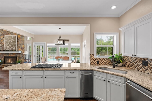 10198 Castanedo Ct, Keithville, LA 71047 - kitchen featuring appliances with stainless steel finishes, a sink, a peninsula, white cabinetry, and tasteful backsplash