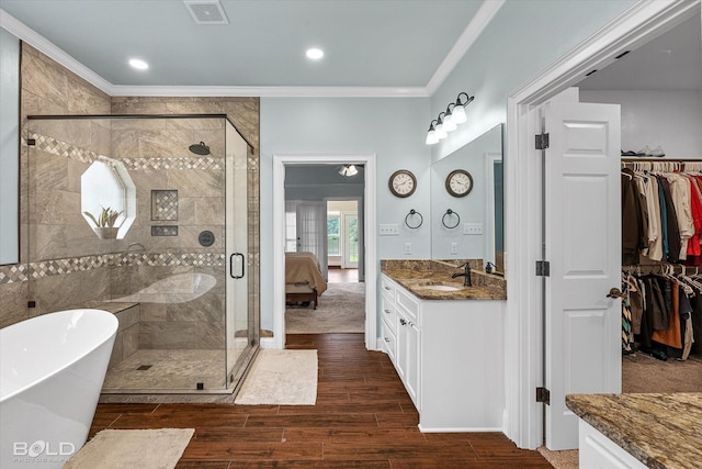 10198 Castanedo Ct, Keithville, LA 71047 - full bath featuring ornamental molding, vanity, a shower stall, wood finished floors, and a walk in closet