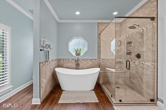 10198 Castanedo Ct, Keithville, LA 71047 - full bath with ornamental molding, healthy amount of natural light, tile walls, a freestanding tub, and wood finished floors