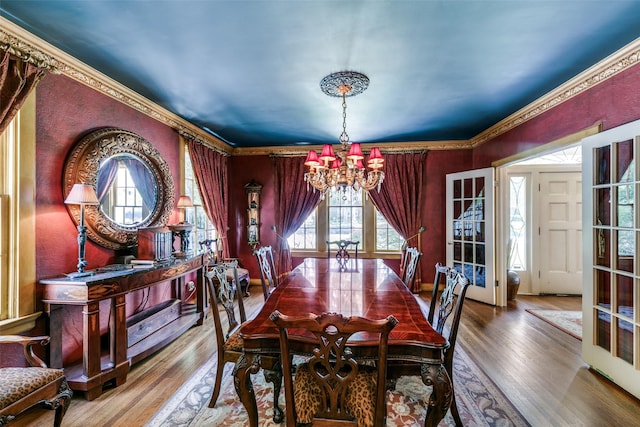 4317 Rawlins St, Dallas, TX 75219 - dining area with a chandelier, wood finished floors, and ornamental molding