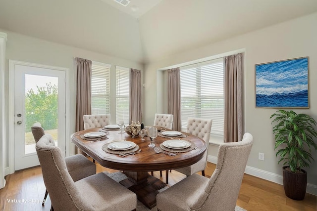 2614 Dakota Cir, Corinth, TX 76210 - dining space featuring plenty of natural light, light wood finished floors, baseboards, and a towering ceiling