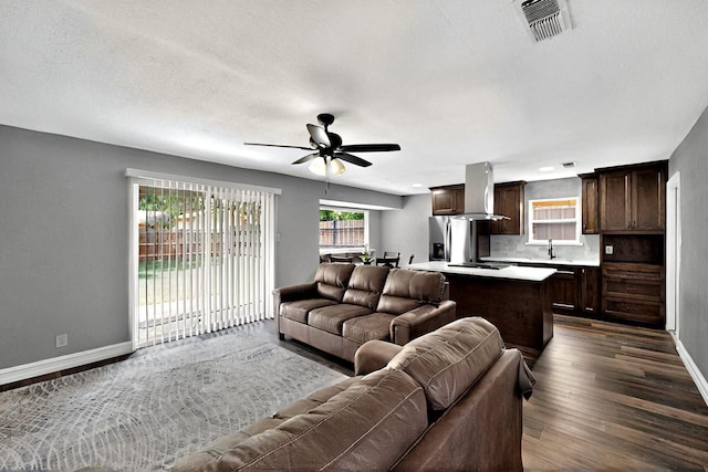6912 Griggs St, Forest Hill, TX 76140 - living area with baseboards, dark wood finished floors, and a ceiling fan