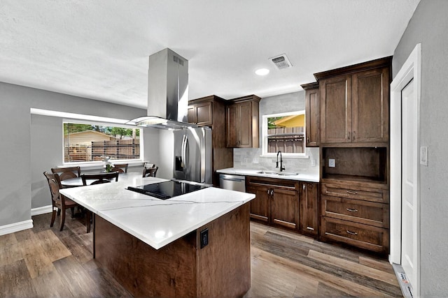 6912 Griggs St, Forest Hill, TX 76140 - kitchen with a sink, appliances with stainless steel finishes, dark wood-style floors, a kitchen island, and recessed lighting