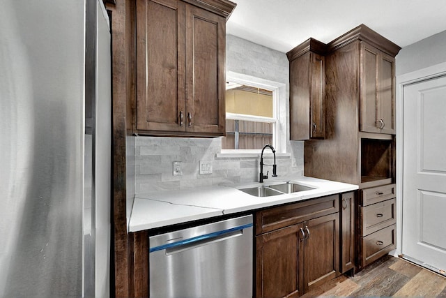 6912 Griggs St, Forest Hill, TX 76140 - kitchen with stainless steel appliances, a sink, dark wood-type flooring, light countertops, and backsplash