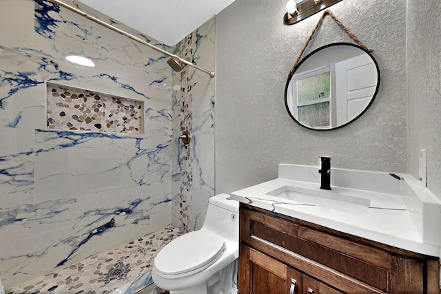 6912 Griggs St, Forest Hill, TX 76140 - bathroom featuring a textured wall, toilet, a marble finish shower, and vanity
