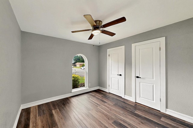 6912 Griggs St, Forest Hill, TX 76140 - unfurnished bedroom with dark wood-style floors, baseboards, and a ceiling fan