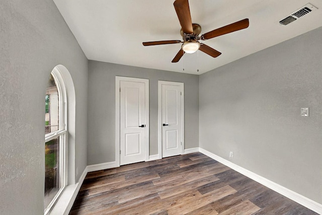 6912 Griggs St, Forest Hill, TX 76140 - unfurnished bedroom featuring dark wood-style floors, baseboards, and ceiling fan