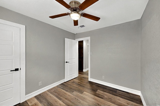 6912 Griggs St, Forest Hill, TX 76140 - unfurnished bedroom featuring baseboards, dark wood finished floors, and a ceiling fan