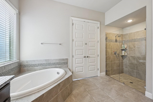 13736 Kevin Dr, Frisco, TX 75035 - bathroom featuring a bath, a stall shower, tile patterned flooring, and vanity