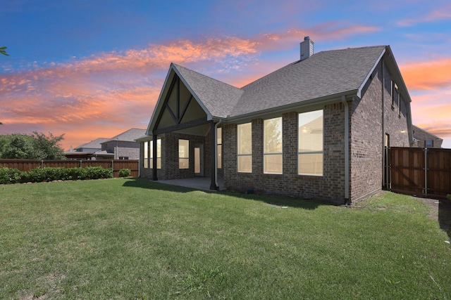 13736 Kevin Dr, Frisco, TX 75035 - back of house featuring a chimney, brick siding, roof with shingles, and a patio