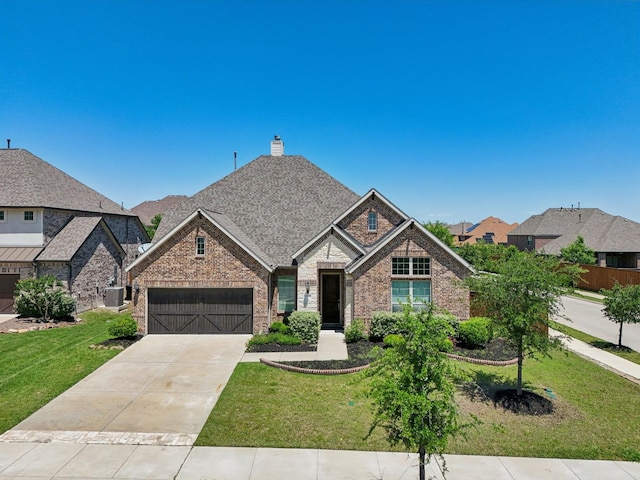 13736 Kevin Dr, Frisco, TX 75035 - view of front of property with brick siding, a garage, concrete driveway, and a front yard