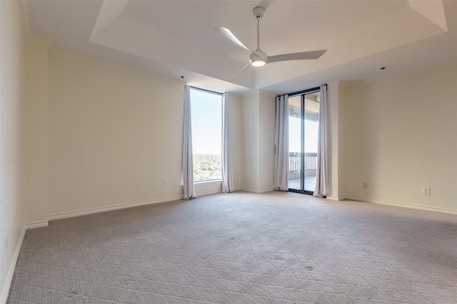 5909 Luther Ln Unit 2200, Dallas, TX 75225 - spare room with a ceiling fan, light carpet, crown molding, baseboards, and a tray ceiling