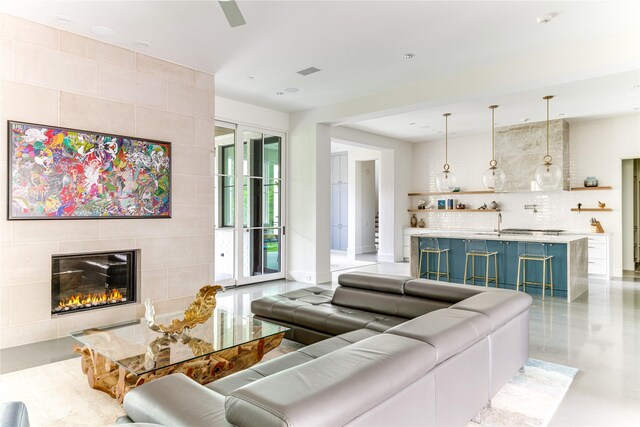 8404 Swananoah Rd, Dallas, TX 75209 - living area with a tiled fireplace, bar area, baseboards, and a ceiling fan