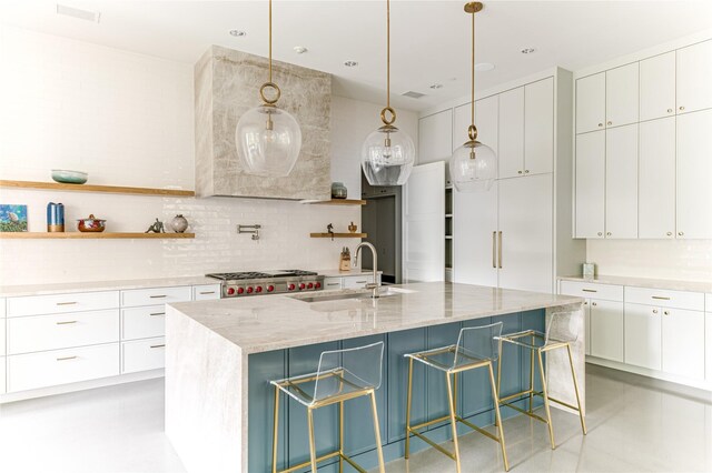 8404 Swananoah Rd, Dallas, TX 75209 - kitchen featuring open shelves, a sink, decorative backsplash, and light stone countertops
