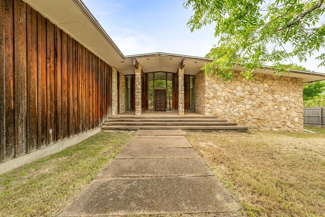4208 Shore Front Dr, Fort Worth, TX 76135 - property entrance with stone siding, a yard, and a porch