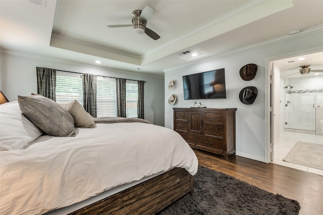 7514 Caillet St, Dallas, TX 75209 - bedroom featuring ornamental molding, dark wood-style flooring, a tray ceiling, ensuite bath, and baseboards
