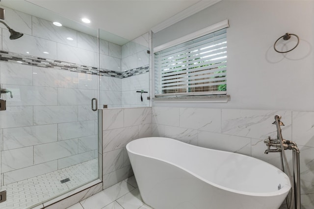 7514 Caillet St, Dallas, TX 75209 - bathroom with a shower stall, a freestanding bath, tile walls, crown molding, and marble finish flooring