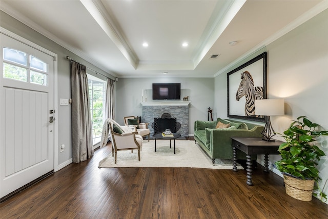 7514 Caillet St, Dallas, TX 75209 - living area featuring dark wood-style flooring, a stone fireplace, a raised ceiling, ornamental molding, and baseboards