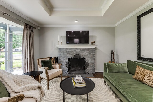 7514 Caillet St, Dallas, TX 75209 - living room featuring wood finished floors, a tray ceiling, healthy amount of natural light, a fireplace, and ornamental molding