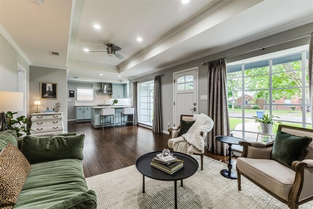 7514 Caillet St, Dallas, TX 75209 - living area featuring ornamental molding, ceiling fan, dark wood-style floors, a tray ceiling, and plenty of natural light
