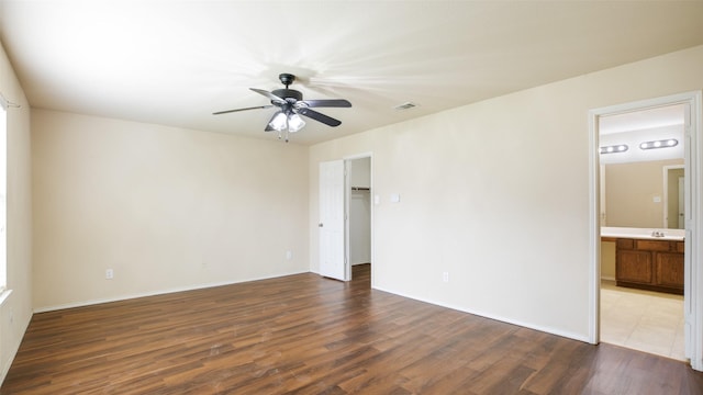 1508 Mockingbird Dr, Aubrey, TX 76227 - unfurnished bedroom featuring wood finished floors, ensuite bath, a spacious closet, baseboards, and a ceiling fan