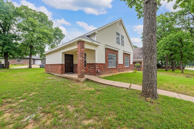 10315 Budtime Ln, Dallas, TX 75217 - view of front of house featuring brick siding, a front lawn, and covered porch