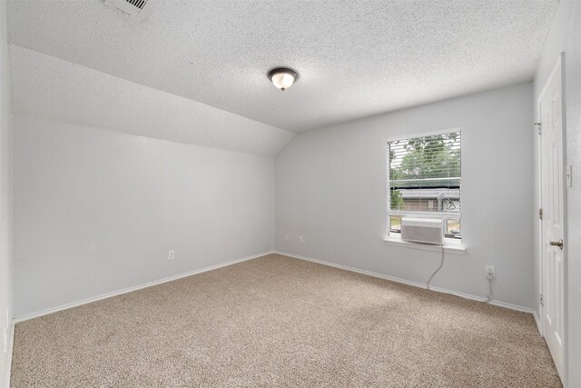 10315 Budtime Ln, Dallas, TX 75217 - carpeted empty room with lofted ceiling, a textured ceiling, and baseboards