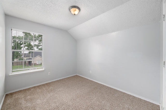 10315 Budtime Ln, Dallas, TX 75217 - bonus room featuring carpet, lofted ceiling, a textured ceiling, and baseboards