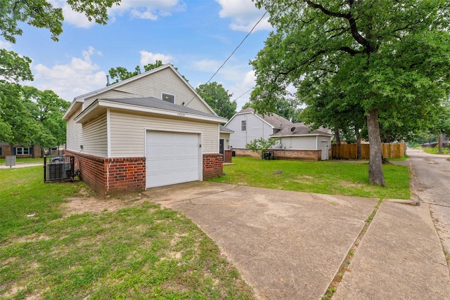 10315 Budtime Ln, Dallas, TX 75217 - view of home's exterior featuring brick siding, a garage, and concrete driveway