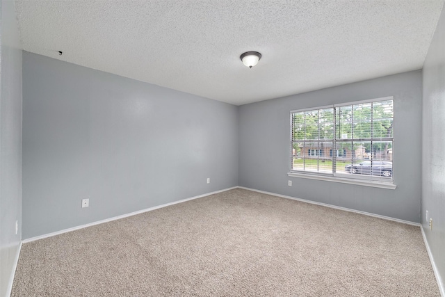10315 Budtime Ln, Dallas, TX 75217 - spare room featuring carpet flooring, a textured ceiling, and baseboards