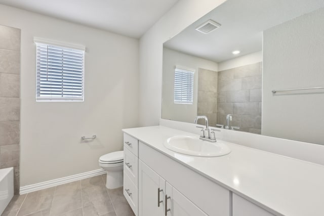 510 Willet Dr, Mckinney, TX 75069 - bathroom with baseboards, toilet, vanity, a tub to relax in, and tile patterned floors