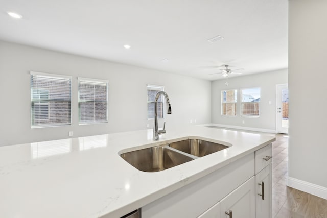 510 Willet Dr, Mckinney, TX 75069 - kitchen with a sink, light stone countertops, white cabinets, open floor plan, and ceiling fan
