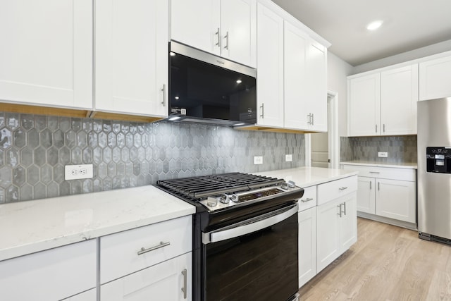 510 Willet Dr, Mckinney, TX 75069 - kitchen featuring appliances with stainless steel finishes, light wood finished floors, white cabinetry, tasteful backsplash, and light stone counters