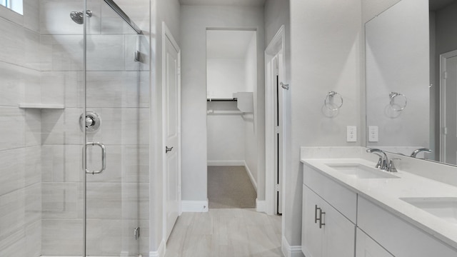 516 Willet Dr, Mckinney, TX 75069 - bathroom featuring a stall shower, double vanity, and a walk in closet